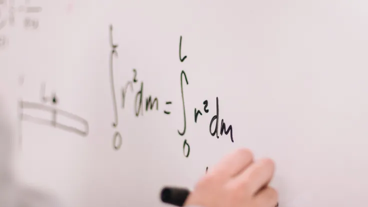 White board with math equation courtesy of jeswin thomas from unsplash.com