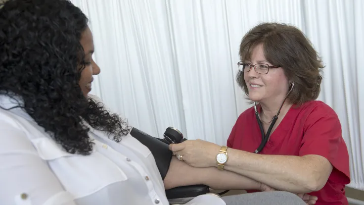 Healthcare technician taking blood pressure