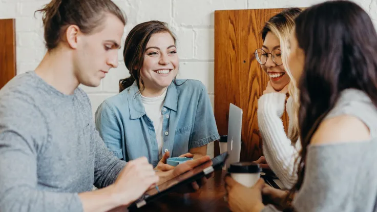 four students studying at a table